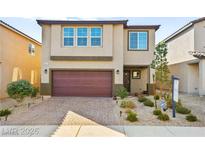 Charming two-story home with a brick driveway, a two-car garage and desert landscaping at 8937 Pelican Point St, Las Vegas, NV 89178