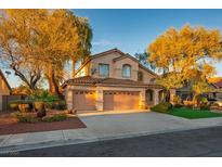 Inviting two-story home with a well-manicured front yard and a three car garage at 2204 Ambermill Ct, Henderson, NV 89052