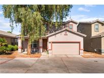 Charming two-story home with a well-maintained lawn and two car garage at 2400 Dutchmans Pipe Ct, Las Vegas, NV 89106