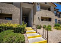 Inviting exterior view of condo building with well-maintained landscaping and stairs to the units at 2451 N Rainbow Blvd # 1116, Las Vegas, NV 89108