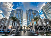 Striking exterior view of the Panorama Towers in Las Vegas with sleek, modern architecture and palm tree landscaping at 4525 Dean Martin Dr # 412, Las Vegas, NV 89103