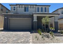 Charming two-story home boasts a brick-paved driveway and inviting covered entryway at 560 Preston Oak Pl, Las Vegas, NV 89138