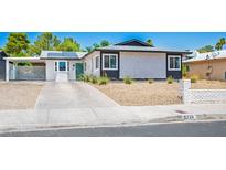 Charming single-story home featuring a covered carport, desert landscaping, and modern solar panels at 6236 Foothill Blvd, Las Vegas, NV 89118