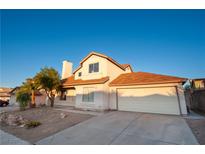 Inviting two-story home featuring a well-maintained lawn and a spacious two-car garage, perfect for comfortable living at 860 Bergamont Dr, Henderson, NV 89002