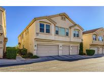 Three-story townhouse featuring a three-car garage and a neutral stucco exterior at 8842 Duncan Barrel Ave # 103, Las Vegas, NV 89178