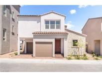 Two-story home with a two-car garage, stone accents and a charming front porch at 1808 Mangrove Ct, Las Vegas, NV 89138