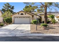 Charming single-story home featuring a two-car garage and well-manicured landscaping at 4908 Winterset Dr, Las Vegas, NV 89130
