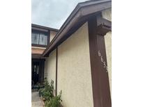 View of the front exterior featuring light stucco walls with brown trim and dark metal security door at 6633 Gazelle Dr, Las Vegas, NV 89108