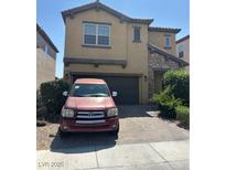 Two-story home showcasing a well-maintained yard and charming architectural details at 7064 Coventry Glenn Rd, Las Vegas, NV 89148