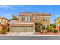 Charming two-story home boasts a three-car garage and meticulously landscaped front yard at 8929 Monte Oro Dr, Las Vegas, NV 89131