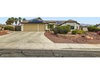 Inviting home features a two-car garage, desert landscaping, and solar panels on the roof at 7404 Wittig Ave, Las Vegas, NV 89131