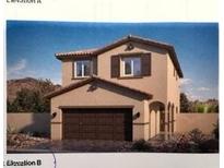 Inviting two-story home with a two-car garage and desert landscaping at 7430 Bo Gable Falls Pl # 54, North Las Vegas, NV 89084