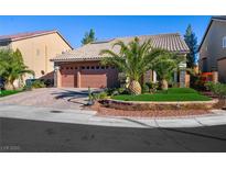 Charming single-story home featuring a well-manicured yard, desert landscaping, and a spacious three-car garage at 10042 Pipestone St, Las Vegas, NV 89141