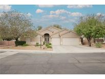 Charming single-story home features a well-manicured yard and a three-car garage at 1598 Cowboy Chaps Pl, Henderson, NV 89002