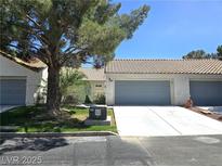 Inviting single story home featuring a charming desert landscape, covered front porch, and an attached two-car garage at 2253 Van Gogh Dr, Henderson, NV 89074