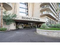 Inviting entrance to Regency Towers with lush landscaping and well-maintained facade at 3111 Bel Air Dr # 12E, Las Vegas, NV 89109