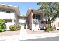 Inviting two-story condo building featuring well-maintained landscaping and a charming walkway at 698 Oakmont Ave # 1310, Las Vegas, NV 89109