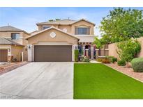 Charming two-story home featuring a well-manicured front yard, covered entry, and a two-car garage at 7013 Bisoni St, Las Vegas, NV 89149