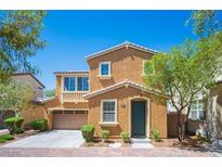 Charming two-story home with a well-manicured lawn and a cozy front porch at 8368 Creek Canyon Ave, Las Vegas, NV 89113