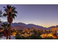 Scenic community view with palm trees set against a mountain backdrop at twilight at 10536 Abisso Dr, Las Vegas, NV 89135