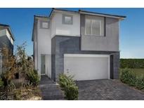 Modern two-story home featuring gray and white stucco, brick accents, and a two-car garage at 1552 Pacific Baza St, Las Vegas, NV 89138