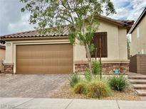 Charming single-story home featuring a two-car garage, stone accents, and desert landscaping at 4117 Midnight Crest Ave, North Las Vegas, NV 89031