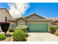 Charming single-story home with desert landscaping and a two-car green garage door at 6057 Leaping Foal St, North Las Vegas, NV 89081