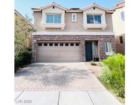 Charming two-story home featuring a stone facade, attached two-car garage, and manicured landscaping at 5932 Pillar Rock Ave, Las Vegas, NV 89139