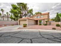 Charming two-story home with a well-manicured front yard and a two-car garage at 9836 Russett Wood Cir, Las Vegas, NV 89117